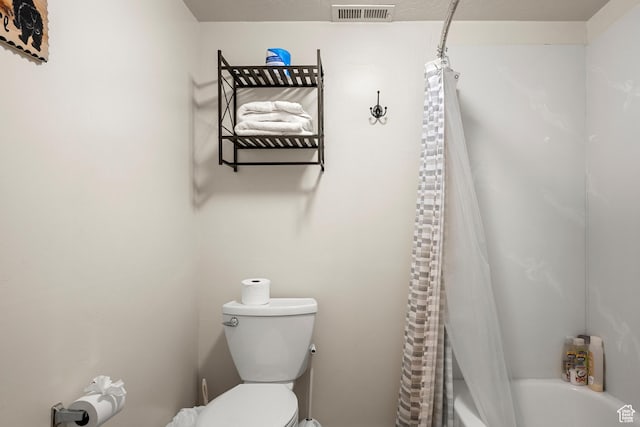 bathroom with toilet and shower / tub combo