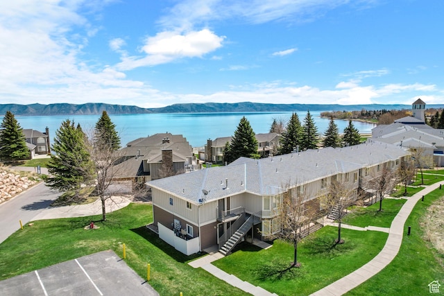 aerial view of residential area featuring a water and mountain view