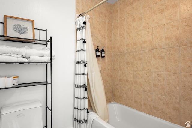 bathroom featuring shower / bath combo and toilet