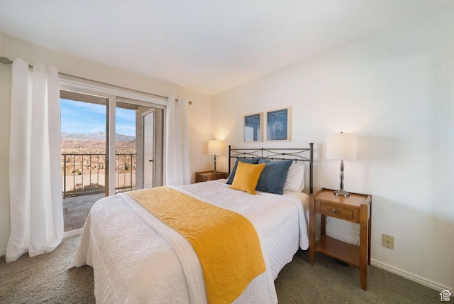 bedroom featuring dark colored carpet, a mountain view, and access to outside