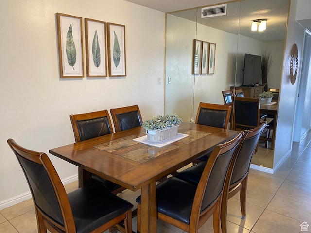 dining area with light tile patterned floors