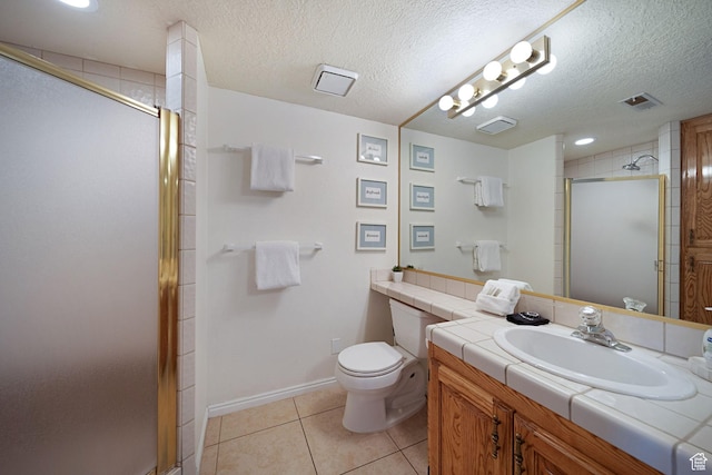 bathroom with tile patterned flooring, toilet, a textured ceiling, and walk in shower