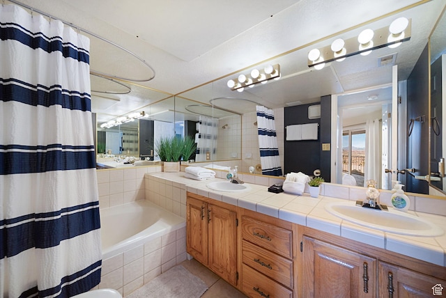 bathroom featuring vanity, shower / bathtub combination with curtain, and tile patterned floors