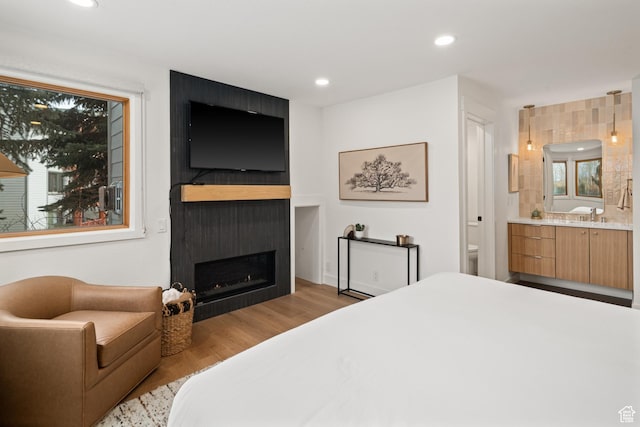 401 Silver King Dr, Park City, UT 84060 - bedroom featuring wood finished floors, ensuite bath, a fireplace, recessed lighting, and multiple windows