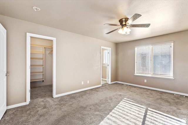 419 E 475 N, Ogden, UT 84404 - unfurnished bedroom featuring light carpet, a walk in closet, a closet, and ceiling fan