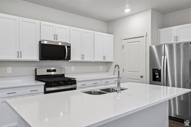 3474 S 3100 W Unit 146, West Haven, UT 84401 - kitchen with a center island with sink, light countertops, white cabinetry, a sink, and appliances with stainless steel finishes