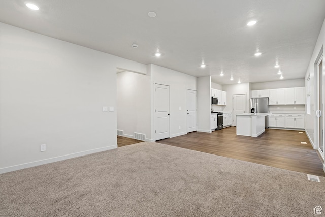 3474 S 3100 W Unit 146, West Haven, UT 84401 - unfurnished living room with dark colored carpet, recessed lighting, baseboards, and visible vents