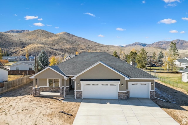 view of front of home featuring a mountain view and a garage