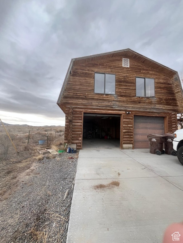 332 S Allens Ranch Rd, Fairfield, UT 84013 - view of property exterior featuring log siding, a detached garage, and concrete driveway