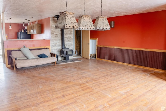 332 S Allens Ranch Rd, Fairfield, UT 84013 - living room with a wood stove, a textured ceiling, and wood finished floors