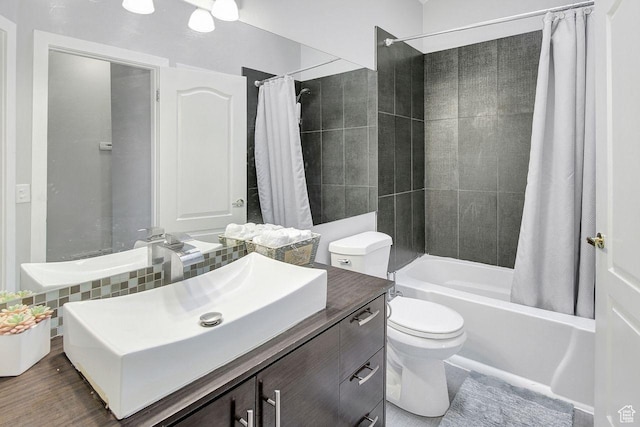 full bathroom with vanity, toilet, and shower / bath combo with shower curtain