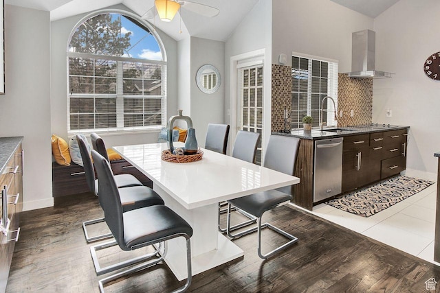 dining area featuring dark hardwood / wood-style floors, ceiling fan, lofted ceiling, and sink