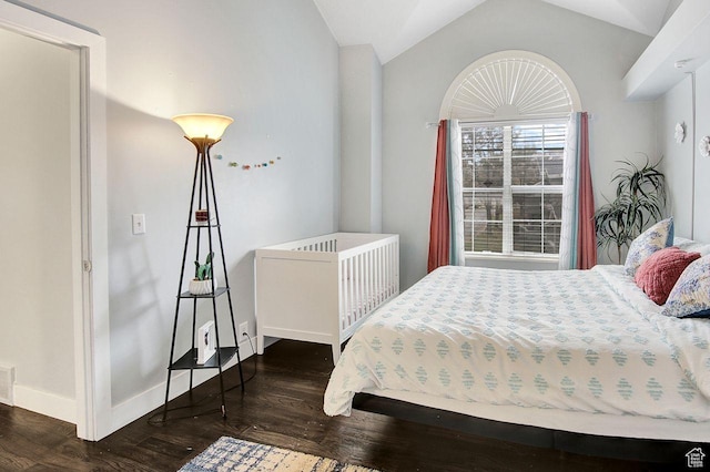 bedroom featuring dark hardwood / wood-style flooring and vaulted ceiling