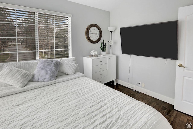 bedroom with dark hardwood / wood-style floors