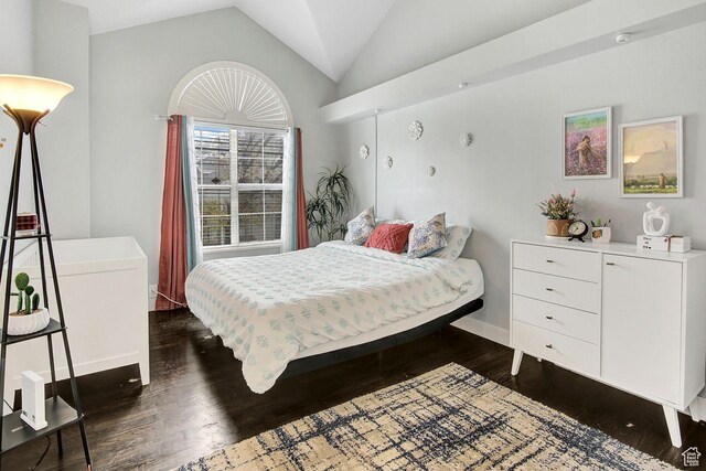 bedroom with dark hardwood / wood-style flooring and vaulted ceiling