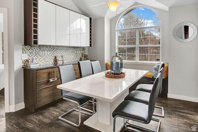 dining space featuring dark hardwood / wood-style floors, ceiling fan, and lofted ceiling