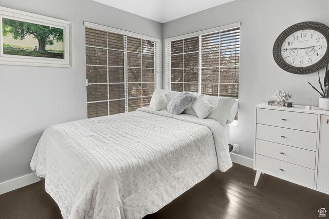 bedroom with dark hardwood / wood-style flooring