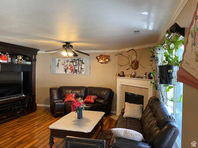 454 S Lincolnshire W, Kaysville, UT 84037 - living room featuring dark wood-type flooring, crown molding, ceiling fan, a textured ceiling, and a tiled fireplace