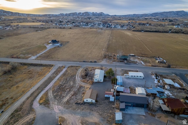 aerial view at dusk featuring a mountain view