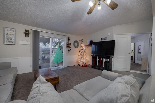 carpeted living room with ceiling fan, lofted ceiling, and a textured ceiling