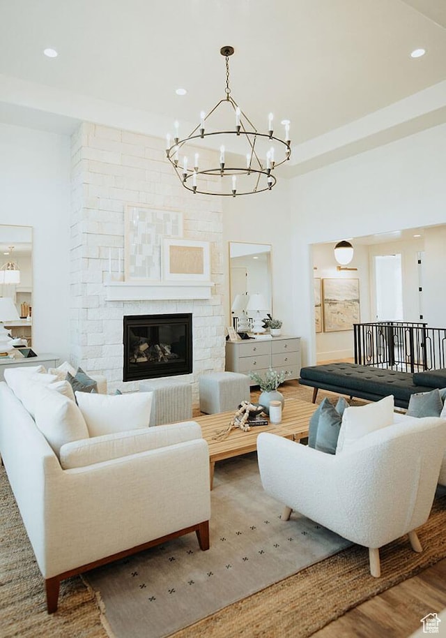 living room with wood-type flooring and a large fireplace