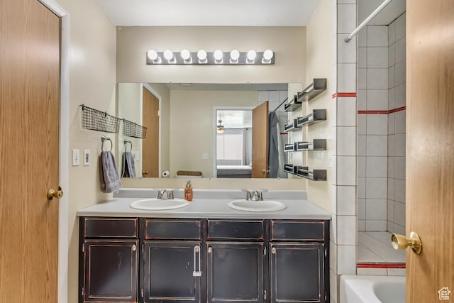 bathroom with double vanity and tub / shower combination