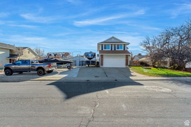traditional-style home featuring concrete driveway and a garage