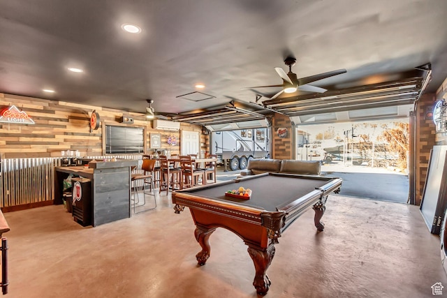 recreation room featuring ceiling fan, concrete flooring, wood walls, billiards, and a wall mounted AC