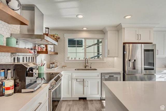 kitchen with open shelves, stainless steel appliances, a sink, island range hood, and recessed lighting