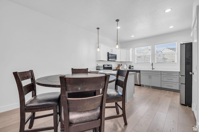 13963 S Wide Ridge Way Unit 1121, Herriman, UT 84096 - dining room with a textured ceiling and light hardwood / wood-style flooring
