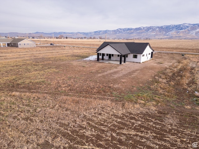 drone / aerial view with a mountain view and a rural view