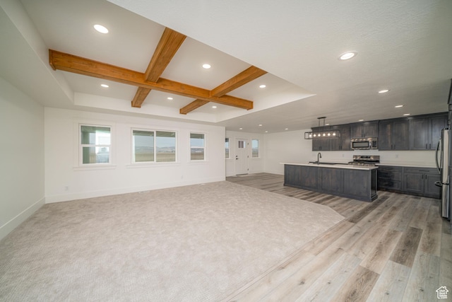 living room featuring beamed ceiling, light hardwood / wood-style floors, coffered ceiling, and sink