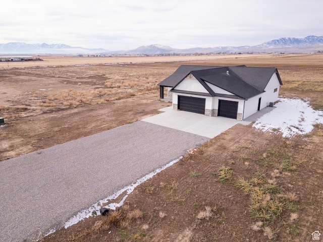 drone / aerial view featuring a mountain view and a rural view