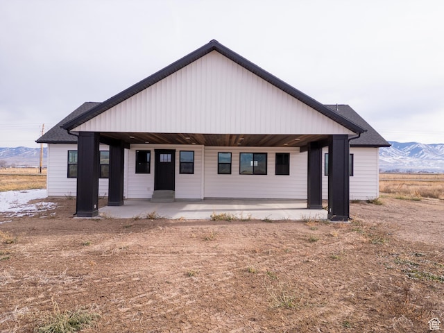 view of front of home with a mountain view and a porch