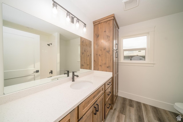 bathroom featuring hardwood / wood-style floors, vanity, and toilet