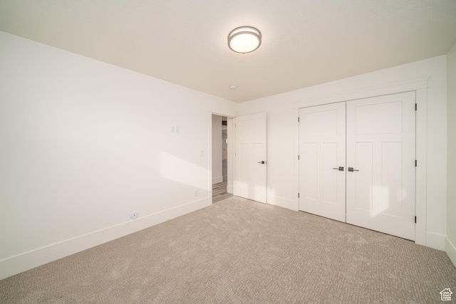 unfurnished bedroom featuring a closet and carpet floors