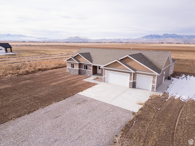 view of front of property with a mountain view and a garage