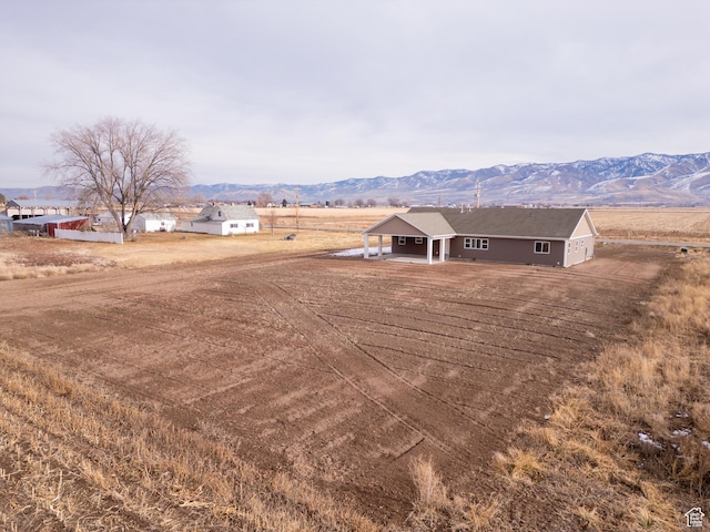 view of yard with a mountain view and a rural view