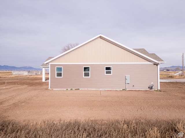 view of side of home with a mountain view