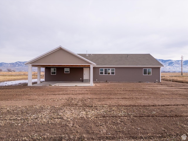 rear view of property with a patio area and a mountain view