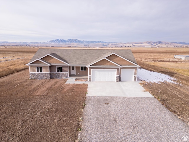 view of front of house featuring a mountain view, a garage, and covered porch