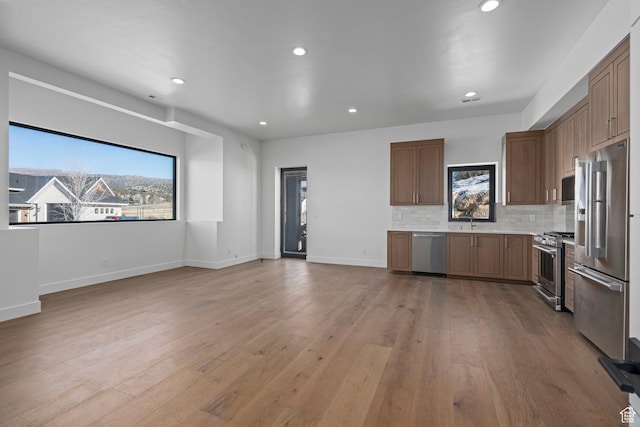 3050 Country Crossings, Heber City, UT 84032 - kitchen featuring stainless steel appliances, light countertops, recessed lighting, light wood finished floors, and backsplash