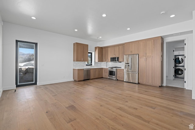 3050 Country Crossings, Heber City, UT 84032 - kitchen featuring appliances with stainless steel finishes, stacked washing machine and dryer, light wood finished floors, light countertops, and recessed lighting