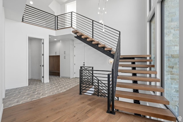 3050 Country Crossings, Heber City, UT 84032 - staircase featuring a high ceiling, parquet flooring, and plenty of natural light