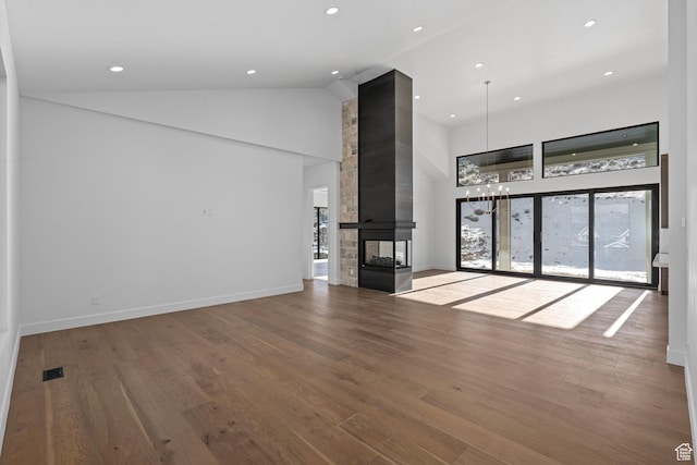 3050 Country Crossings, Heber City, UT 84032 - unfurnished living room with high vaulted ceiling, recessed lighting, wood finished floors, a chandelier, and a multi sided fireplace