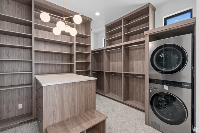 3050 Country Crossings, Heber City, UT 84032 - laundry room featuring stacked washer / dryer, light carpet, a chandelier, and recessed lighting
