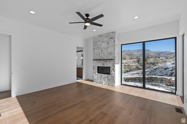 3050 Country Crossings, Heber City, UT 84032 - unfurnished living room with a ceiling fan, a fireplace, wood finished floors, and recessed lighting