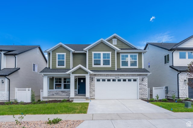 13735 S Devers Dr Unit 2108, Riverton, UT 84096 - view of front of home with concrete driveway, a garage, stone siding, and covered porch