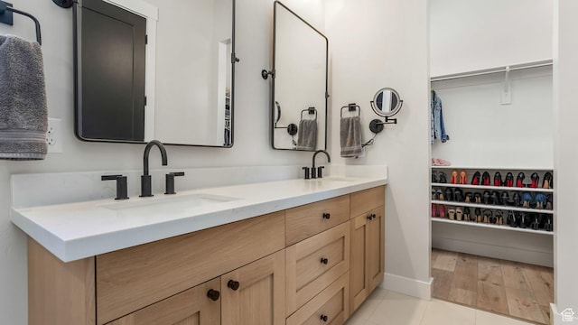 928 N Foxhunter Dr W, Farmington, UT 84025 - full bathroom with double vanity, a walk in closet, and baseboards