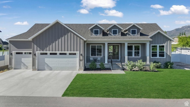 928 N Foxhunter Dr W, Farmington, UT 84025 - view of front of property featuring board and batten siding, a porch, driveway, a garage, and roof with shingles